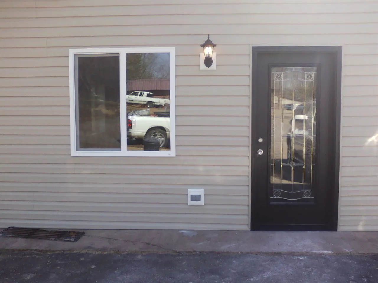 New siding, window and entry door on the side of an addition in Oak Forest