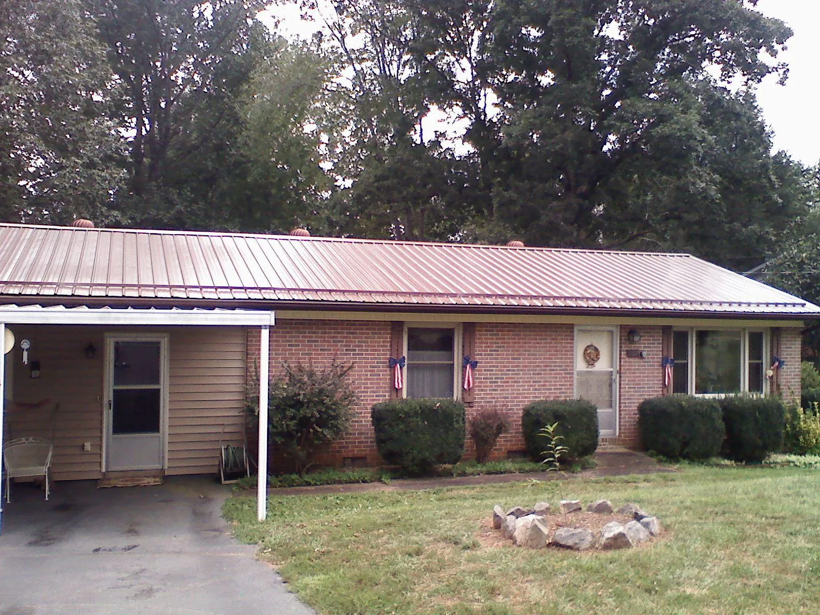Bronze metal roof and carport on a brick ranch home — Roof Repair work by our crew in Oak Forest