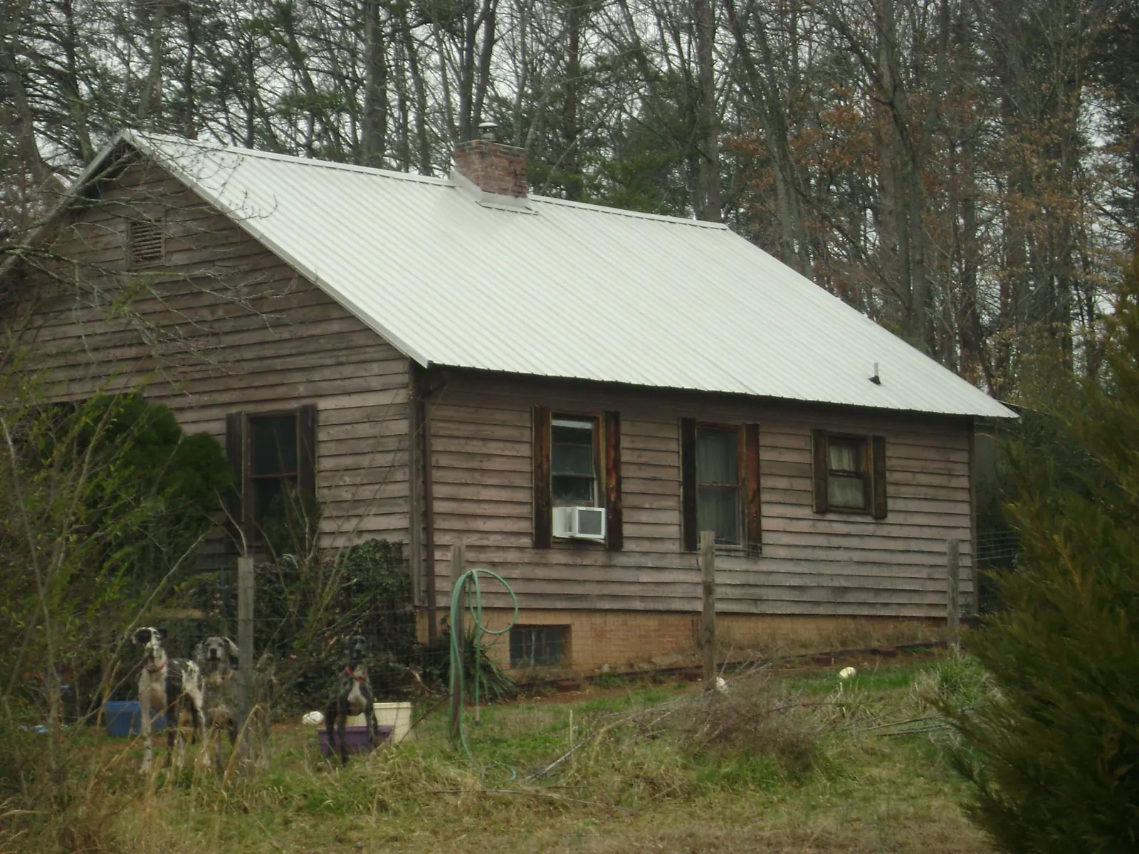 White metal roof on an old wood sided farmhouse, from a Metal Roof Installation job in Oak Forest